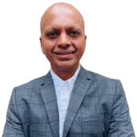 Kishore Subramanian headshot Headshot of a man in a collared shirt and suit coat