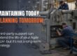 Two industrial technicians servicing a large manufacturing machine, representing long-term maintenance and legacy Agile PLM support.